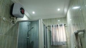a bathroom with a shower with a shower curtain at Emglo Suite in Lagos