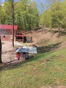 a yard with a house and a picnic table in a field at Ranč Pavić in Banja Luka