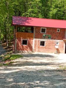 a red brick building with a red roof at Ranč Pavić in Banja Luka +6 photos