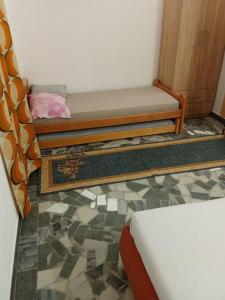 a bedroom with a bed and a tiled floor at Ranč Pavić in Banja Luka