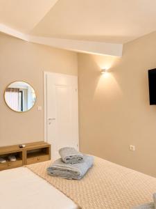 a bedroom with a bed and a mirror at Villa Lucija in Ohrid
