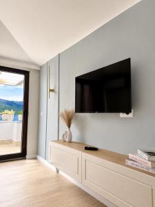 a living room with a flat screen tv on a wall at Villa Lucija in Ohrid +79 photos