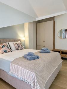 a bedroom with a bed with towels on it at Villa Lucija in Ohrid