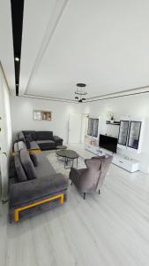 a large living room with couches and a table at Selimi House in Shirokë