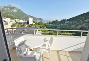 a white table and chairs on a balcony with a view at Hotel Solaris in Čanj