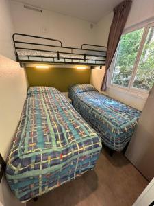 a bedroom with two bunk beds in a room at Camping & Resort Valle Romantica in Cannobio