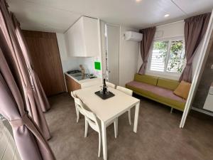 a living room with a table and a couch at Camping & Resort Valle Romantica in Cannobio