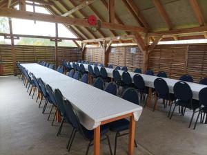 a row of tables and chairs in a barn at Agroturystyka Makowscy in Trzcianka