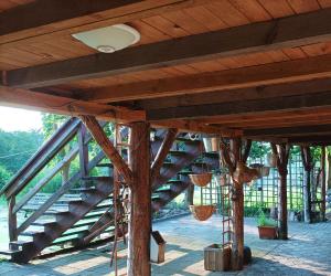 a wooden bridge with baskets hanging from it at Agroturystyka Makowscy in Trzcianka