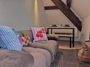 a living room with a couch and a table at The Eaves - Pen Y Fan Views in Brecon