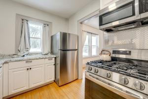 a kitchen with a stainless steel refrigerator and a stove at Walkable 3-Unit Hub: 8 Mi to Micron Technology! in Phoenix