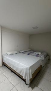 a bedroom with two beds in a room at Pousada Sol Brasil in Fortaleza