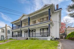a large white house with a balcony at Walkable 3-Unit Hub: 8 Mi to Micron Technology! in Phoenix