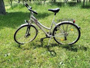 a bike parked in the grass in a field at RIVERSTONE Drašković camp and bungalows in Nikšić
