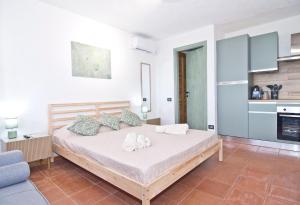 a bedroom with a bed with shoes on it at Charming Open Space in Costa Smeralda in Olbia
