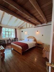 a bedroom with a large bed in a room at IORANA HOTEL Urubamba in Urubamba