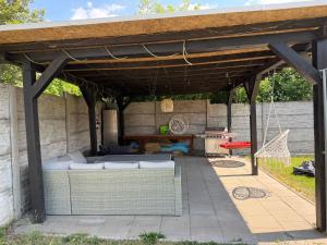 an outdoor patio with a wooden pergola at Holiday House Valaliky in Valaliky