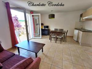 a living room with a couch and a table at Appartement T3 Golf Albret in Barbaste