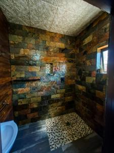 a bathroom with a stone wall and a sink at Mukani B&B in Lobatse +17 photos