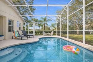 a swimming pool with a ball in the middle at Amazing Star Wars Villa - Theater, Full Arcade & Private Pool, 5BR Near Disney in Orlando +33 photos