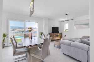 a living room with a table and a couch at Villa Serenity Pag Sv. Marko in Pag