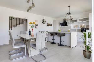 a kitchen and dining room with a table and chairs at Villa Serenity Pag Sv. Marko in Pag