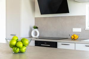 a kitchen with a bowl of fruit on a counter at Villa Serenity Pag Sv. Marko in Pag