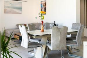 a dining room with a table and chairs at Villa Serenity Pag Sv. Marko in Pag +49 photos
