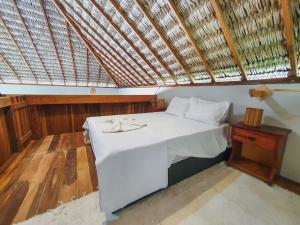 a bedroom with a white bed with a roof at Kite Mansion Arpoador in Tutóia