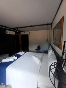 a bedroom with a large white bed in a room at Hotel Estação Chico in Garanhuns