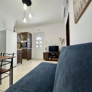 a kitchen and living room with a blue rug at Baloma Apartment in Falasarna