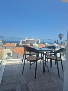 a table and two chairs sitting on a balcony at Proteas Mare Suites in Protaras