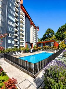 a swimming pool in front of a building at Departamento Villarrica Vista al Volcán y Piscina in Villarrica