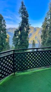 a wooden fence with a view of the mountains at Umda Hotel in Nathia Gali +20 photos