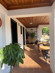 a patio with tables and chairs and a wooden ceiling at Akay Hotel in Selçuk