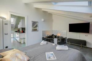 a bedroom with a large bed with a bath tub at Loft & Jacuzzi - Happy Rentals in Riva del Garda +18 photos