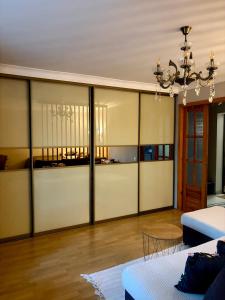 a living room with sliding glass doors and a chandelier at the HAPPY PLACE in Mykolaiv