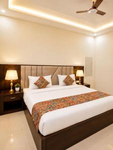 a bedroom with a large bed with two lamps at Hotel Urban Inn - The RK Hospitality Group #Prem Mandir #Chaar Dham Fully AC in Vrindāvan
