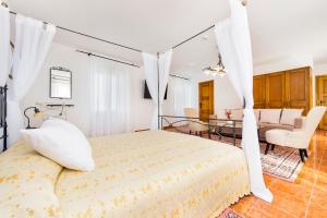 a bedroom with a bed and a living room at Villetta Phasiana in Fažana