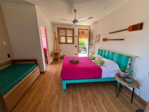 a bedroom with a bed with a pink blanket at Mojarra Beach Casa Privada-Santa Veronica in Salina de Rey