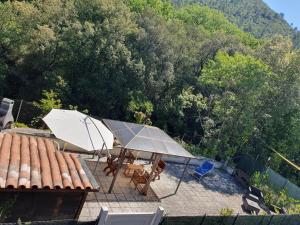 a white umbrella and a table and chairs on a roof at La Terrazza sul Velino in Le Marmore +13 photos