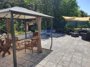 a gazebo with a table and chairs under it at La Terrazza sul Velino in Le Marmore