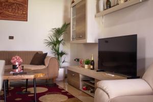 a living room with a television and a couch at CASTLE View SERENITY -- BERAT in Berat
