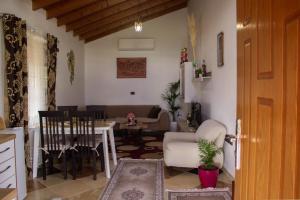 a living room with a table and a dining room at CASTLE View SERENITY -- BERAT in Berat