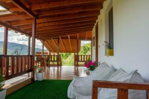 a living room with a porch with a green rug at CASTLE View SERENITY -- BERAT in Berat