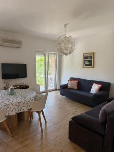 a living room with a blue couch and a table at Apartman Ilaria in Medulin