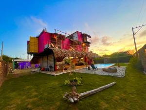 a house with a grass yard with a pool at Mojarra Beach Casa Privada-Santa Veronica in Salina de Rey