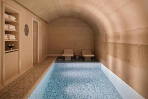 a room with a swimming pool with two benches at The St. Regis Budapest in Budapest +166 photos