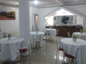 a dining room table with chairs and tables at Hotel Dal Gobo in Ponta Grossa