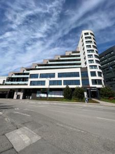a large white building on the side of a street at AH Terrace Jacuzzi Suite near Arena in Košice